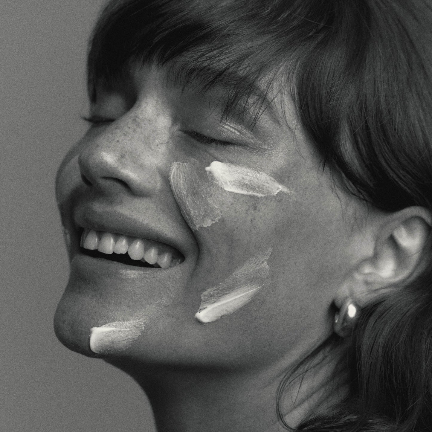 Model wearing African Botanics Intensive Recovery Cream texture regenerative night cream