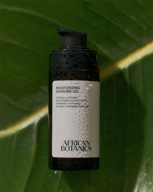 African Botanics Moisturizing Exosome Gel photographed on a dew-covered green leaf