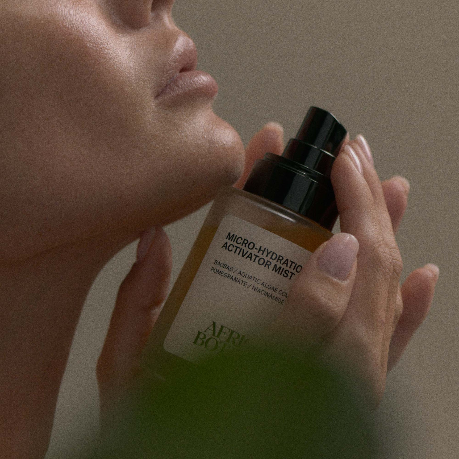 African Botanics Micro-Hydration Activator Mist applied to glowing, hydrated skin