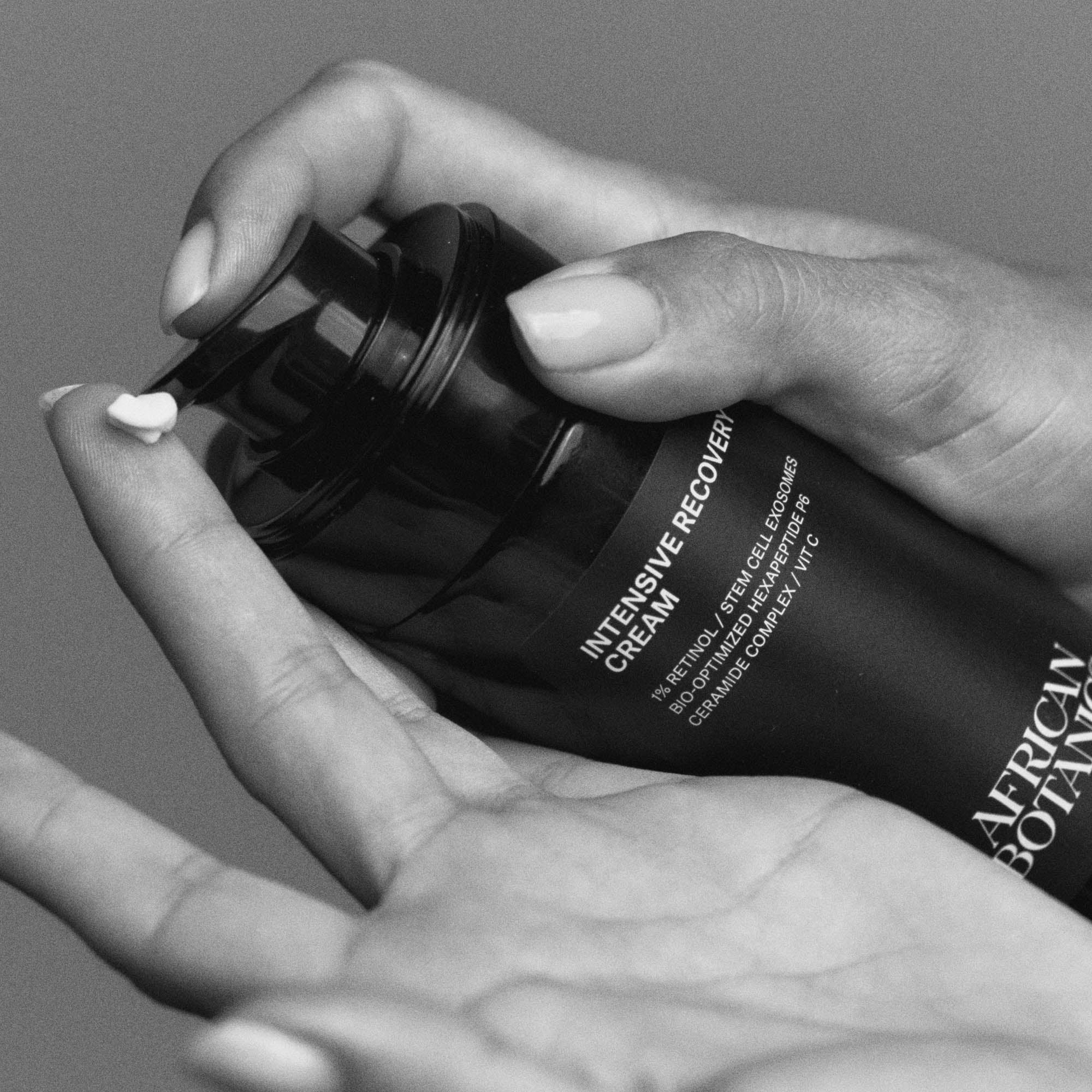 Model applying African Botanics Intensive Recovery Cream rich retinol night treatment