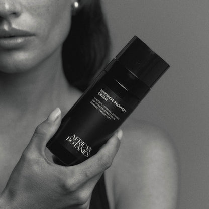 Model holding African Botanics Intensive Recovery Cream regenerative treatment night cream