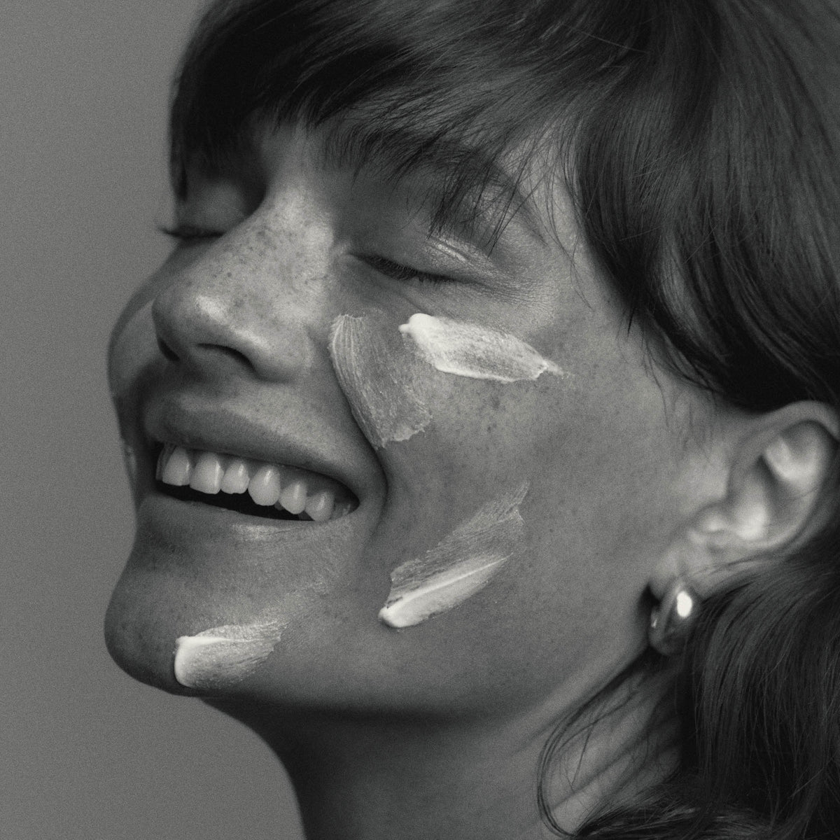 Model wearing African Botanics Intensive Recovery Cream texture regenerative night cream