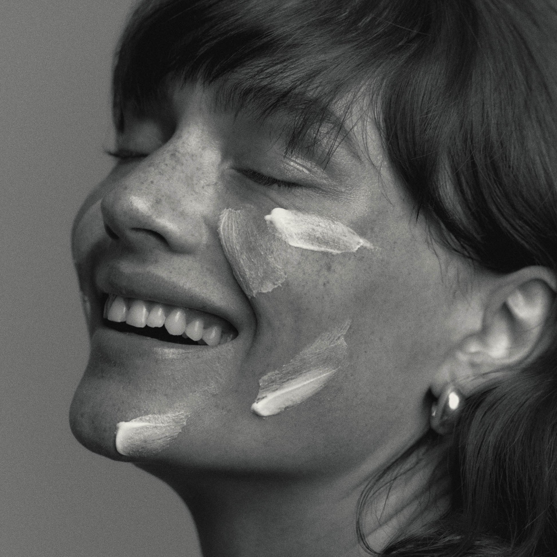 Model wearing African Botanics Intensive Recovery Cream texture regenerative night cream