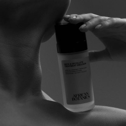 Model applying African Botanics Neck & Décolleté Treatment Emulsion for firmer, lifted skin
