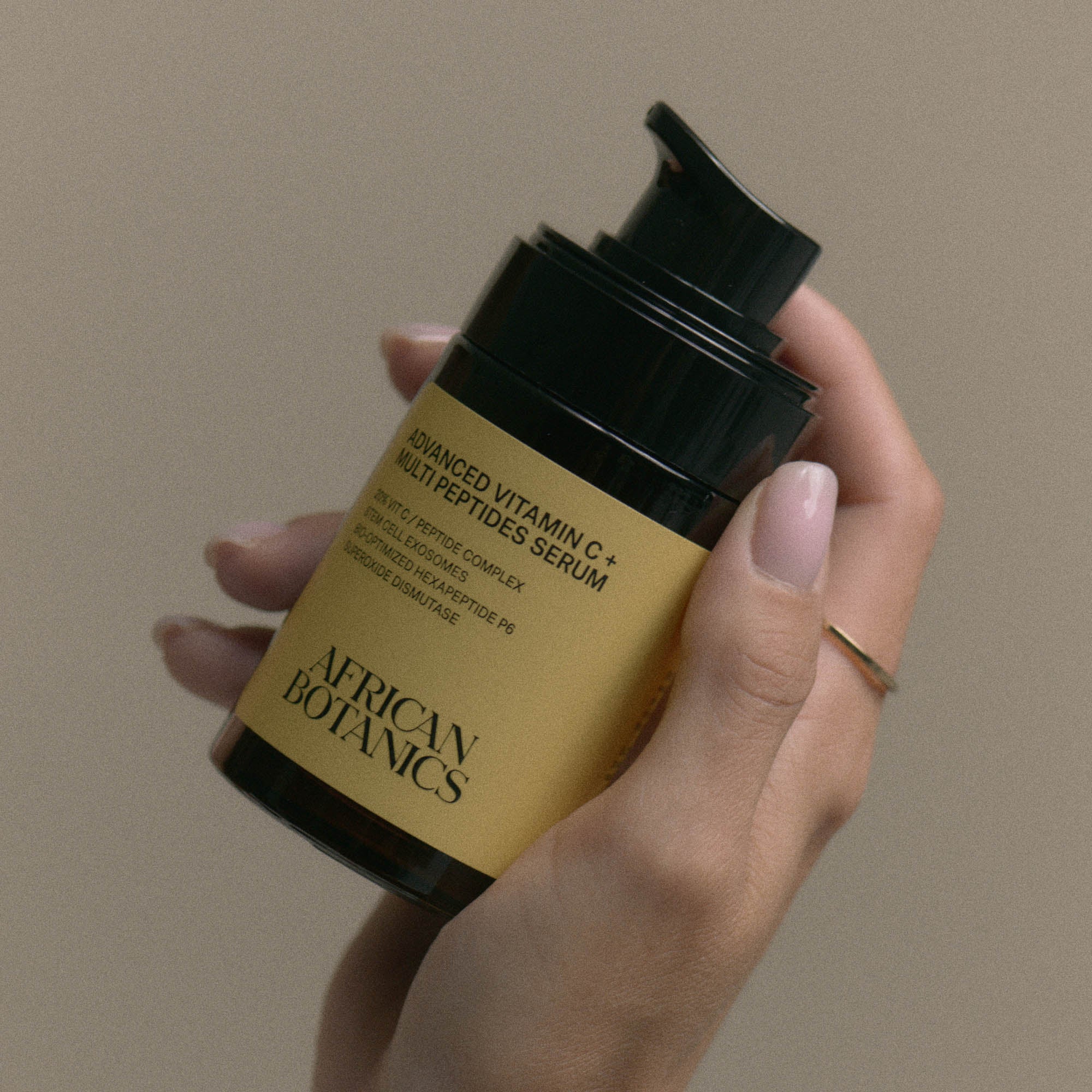 Model holding African Botanics Advanced Vitamin C + Multi Peptides Serum